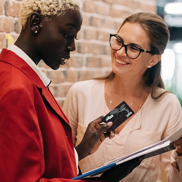 Business woman discuss inventory with their Peach State Business Visa Card