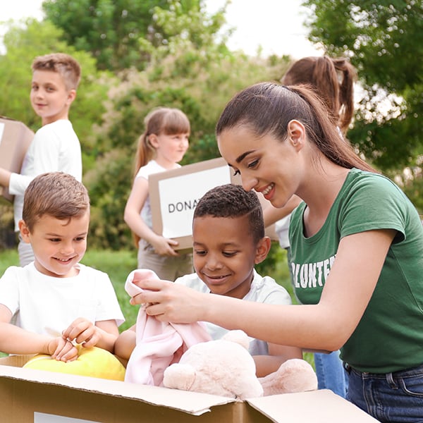 Woman volunteers with local children