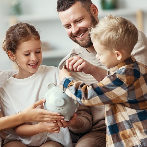 Dad showing children how to save money