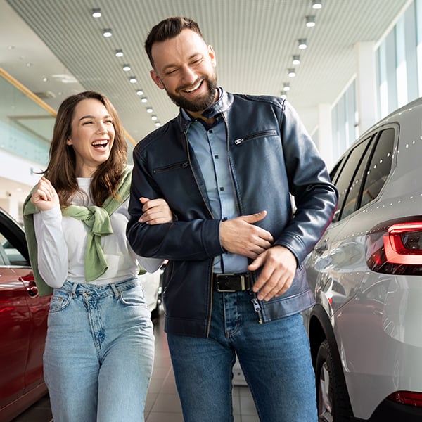 Couple smiles after purchasing new car