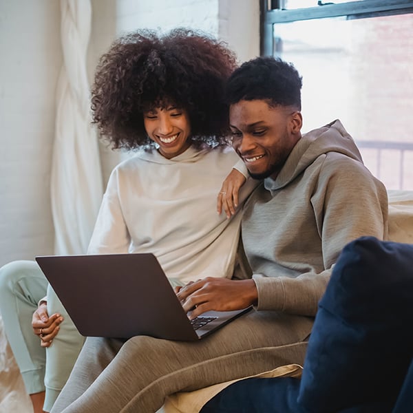 Young couple enjoy online banking at home