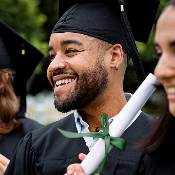 Young guy smiles at graduation