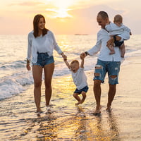 Family enjoys sunset walk on the beach