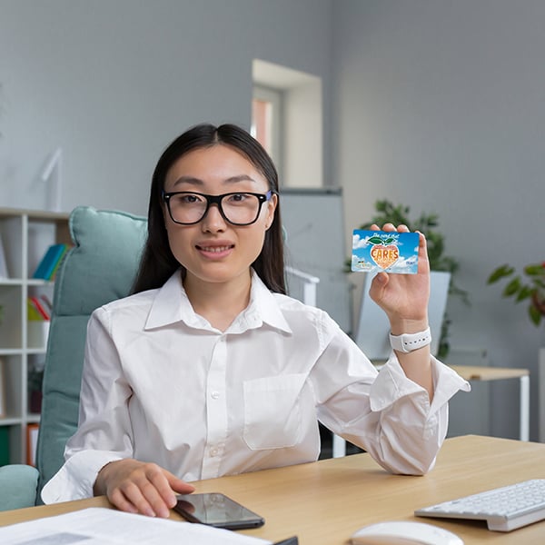 SEG employee shows off her CARES card