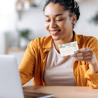 Woman online shops using her Peach State FCU Visa credit card