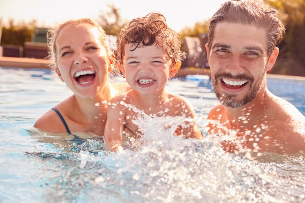 A credit card can bring joy like this family splashing in a pool.