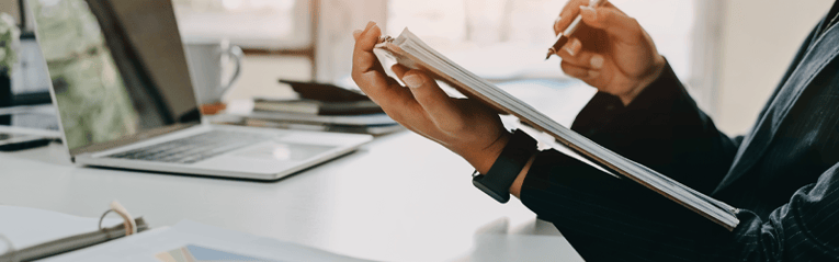 person looking through notebook