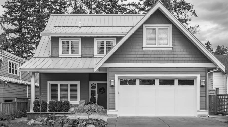 the exterior of a home pictured in black and white