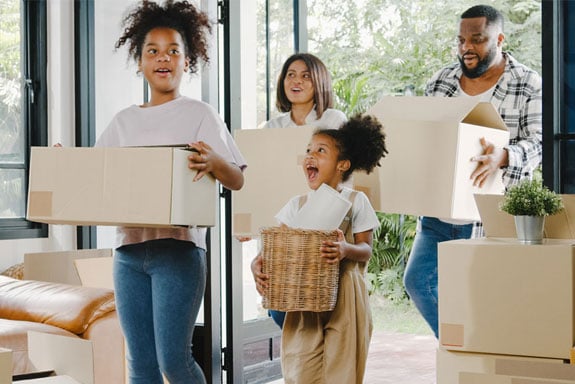 wondering-how-much-house-can-i-afford-peach-state-has-your-answerfor-this-family-walking-into-their-new-home-with-boxes.