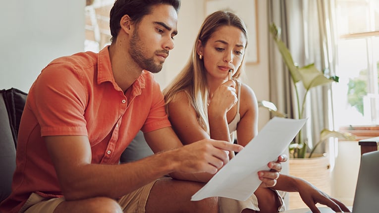 Young couple reviewing their budget