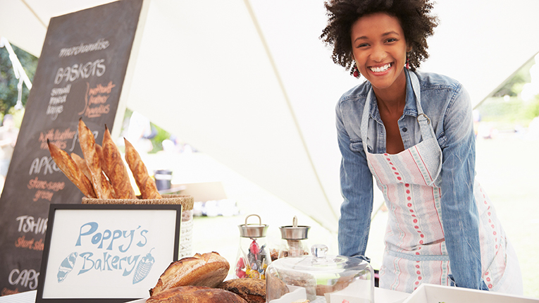 Smiling African American woman running bakery business