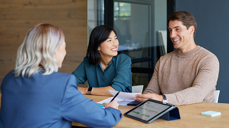Couple meeting fiancial advisor in office