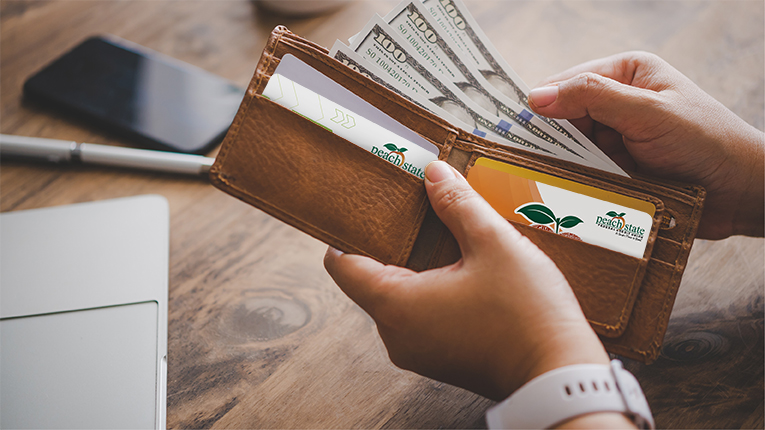 Hand takes out a dollar bill from his pocket to spend.