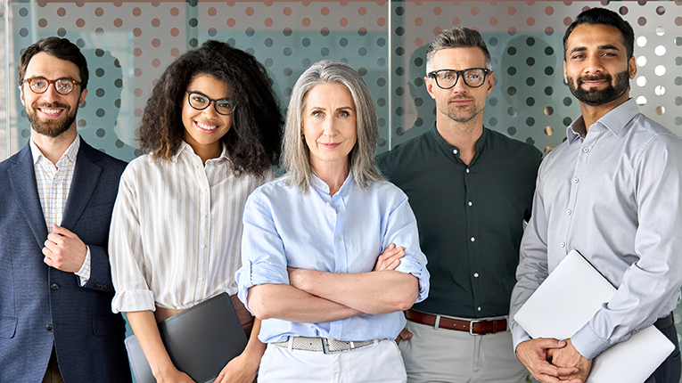 Happy, diverse group of business team standing side by side