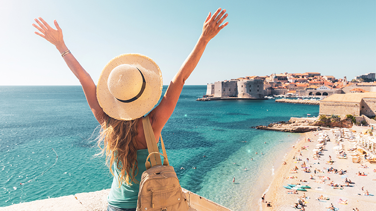 Happy woman tourist enjoying view of the old town of Dubrovnik in Croatia
