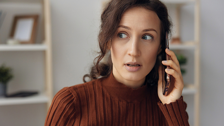 Woman shocked and unsure of who is calling her on her cellphone