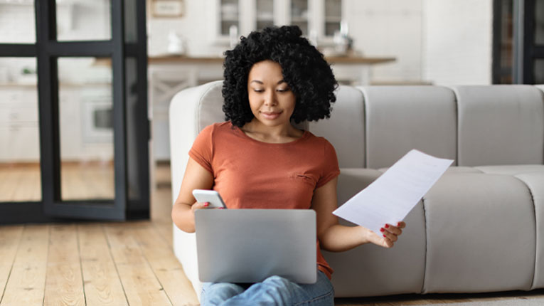 Woman-applying-for-a-credit-union-auto-loan-application-on-her-laptop.