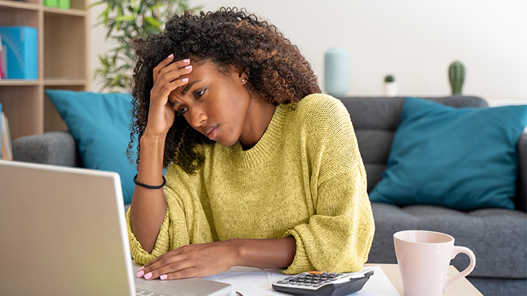 Young black woman having troubles accounting taxes