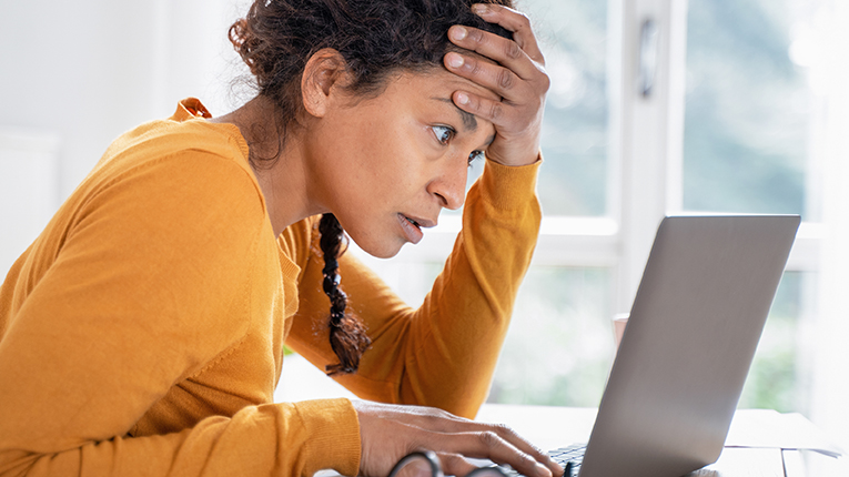 Stressed middle age woman loking at laptop