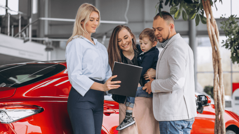 Family-at-car-dealership-realizing-how-much-they-saved-from-using-auto-loan-calculator.