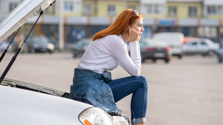 is-car-shopping-in-your-future-peach-state-can-help-woman-with-orange-hair-sitting-on-her-broken-down-car