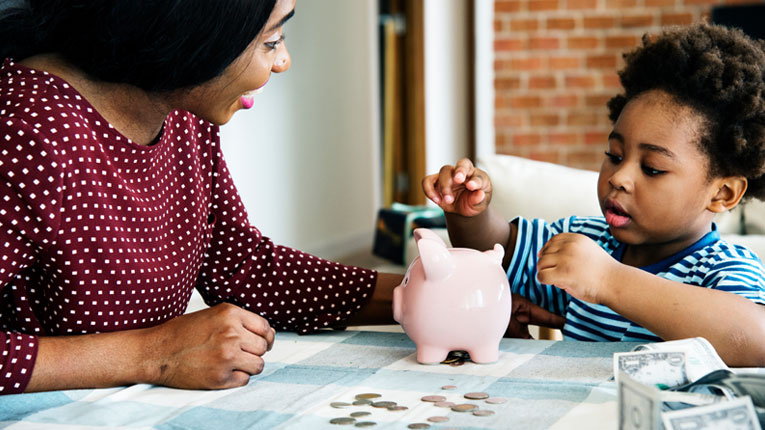 mom and son learning to save change with the help of a kids savings account and peach state