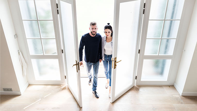 Buying a house can be an enjoyable experience like it is for this couple walking into their new home.