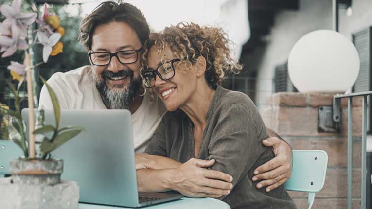 Middle-aged-couple-deciding-is-debt-consolidation-a-good-idea-while-reviewing-their-finances-on-a-laptop-together.