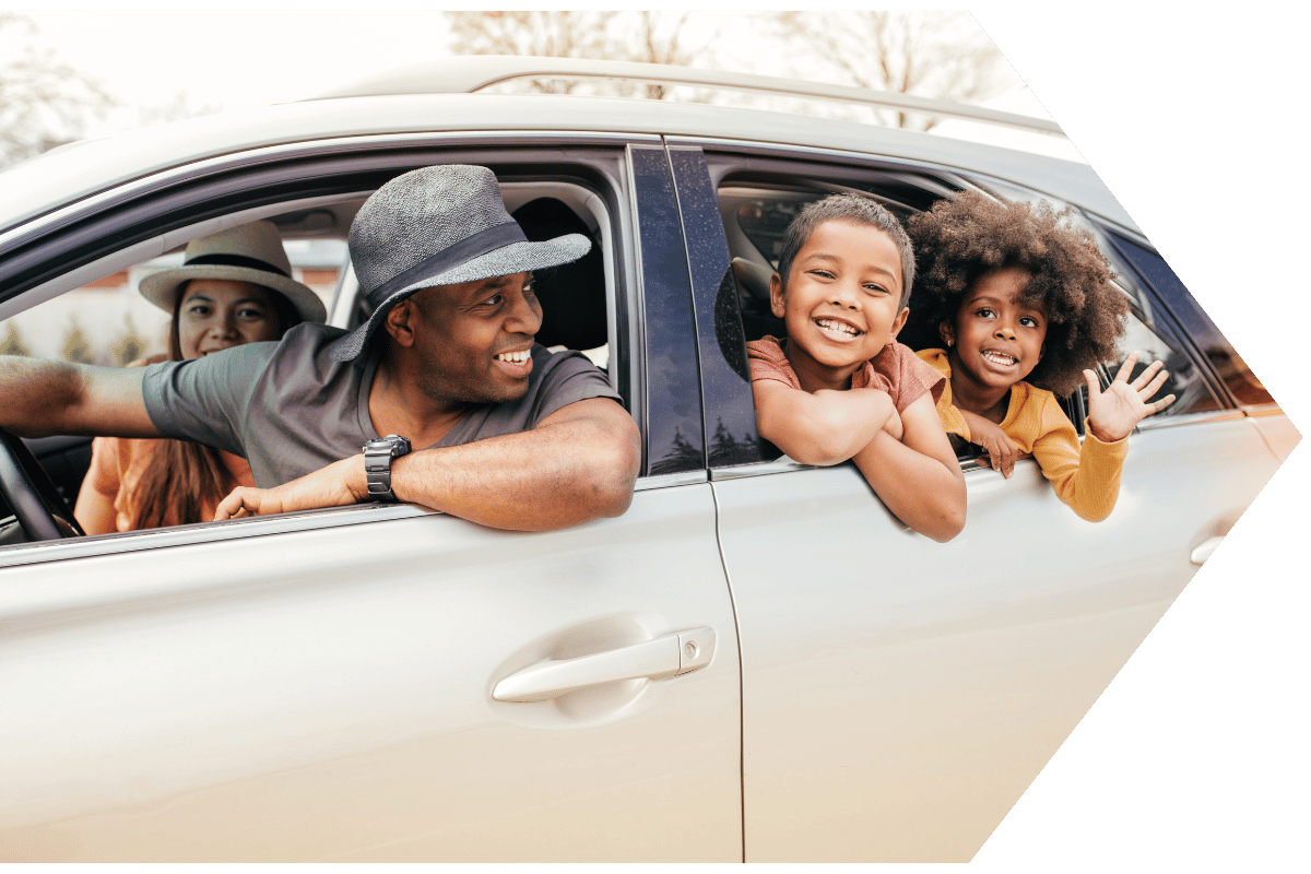 Happy family in their car with an extended car warranty Happy family in their car with an extended car warranty