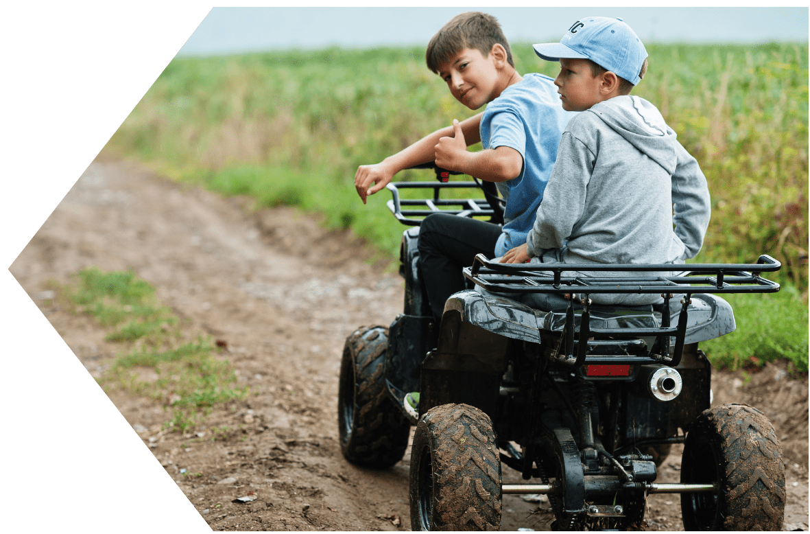 Kids on four wheeler with ATV Loan from Peach State FCU