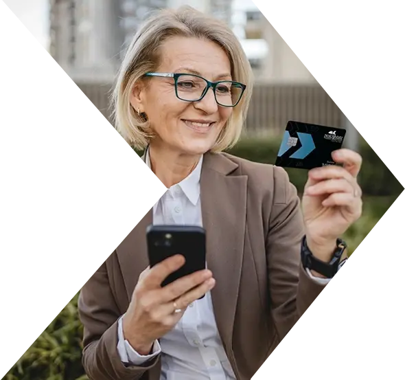 Middle aged business woman uses her PSFCU business visa credit card to make purchase on phone Middle aged business woman uses her PSFCU business visa credit card to make purchase on phone