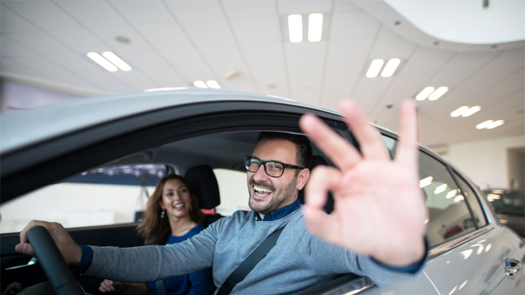 These-smiling-car-buyers-are happy with their purchase because they learned-ways-to-save-money-on-their-new-or-used-car-purchase.