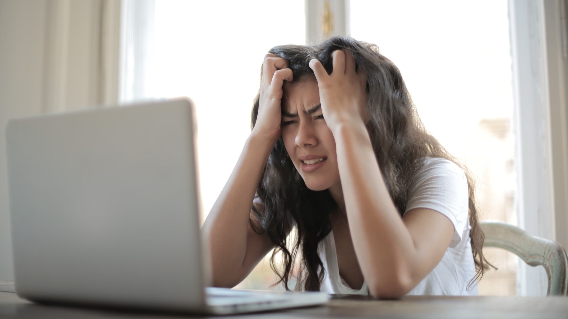 Young woman looking at computer frustrated