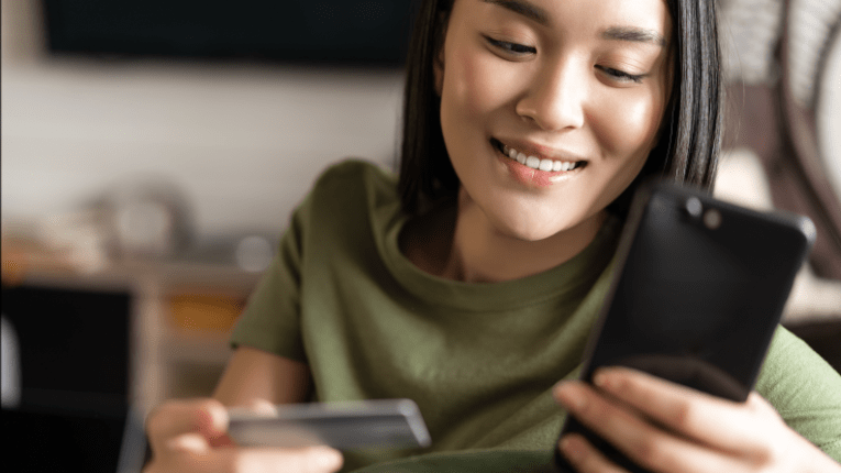 Young woman using her Peach State credit card online